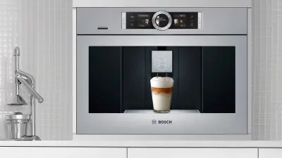 An Coffee Machine, but it is built in a kitchen.